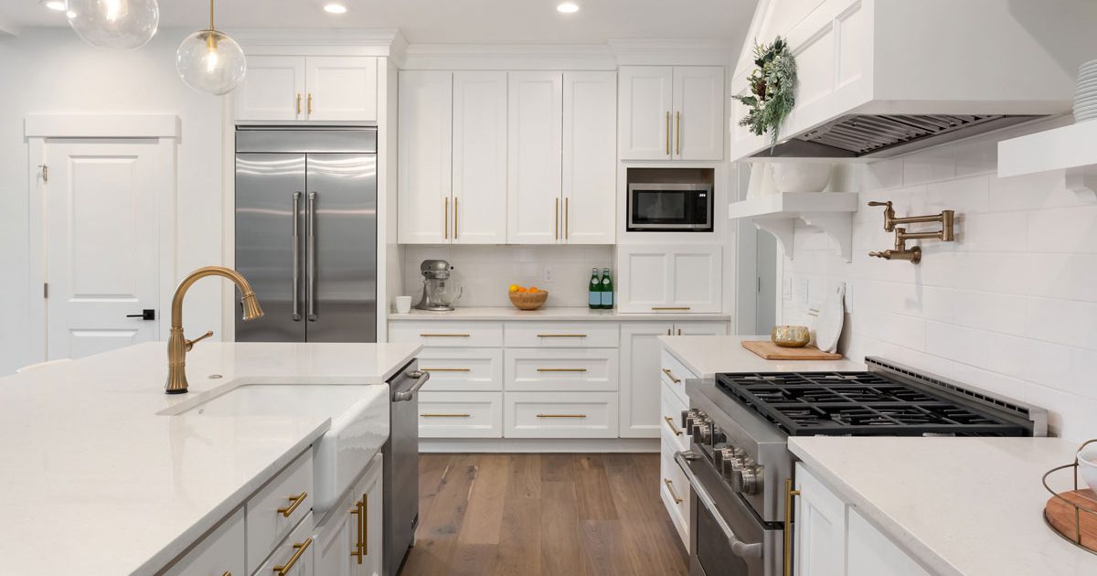 Modern Kitchen Remodel With White Cabinets and Gold Pulls